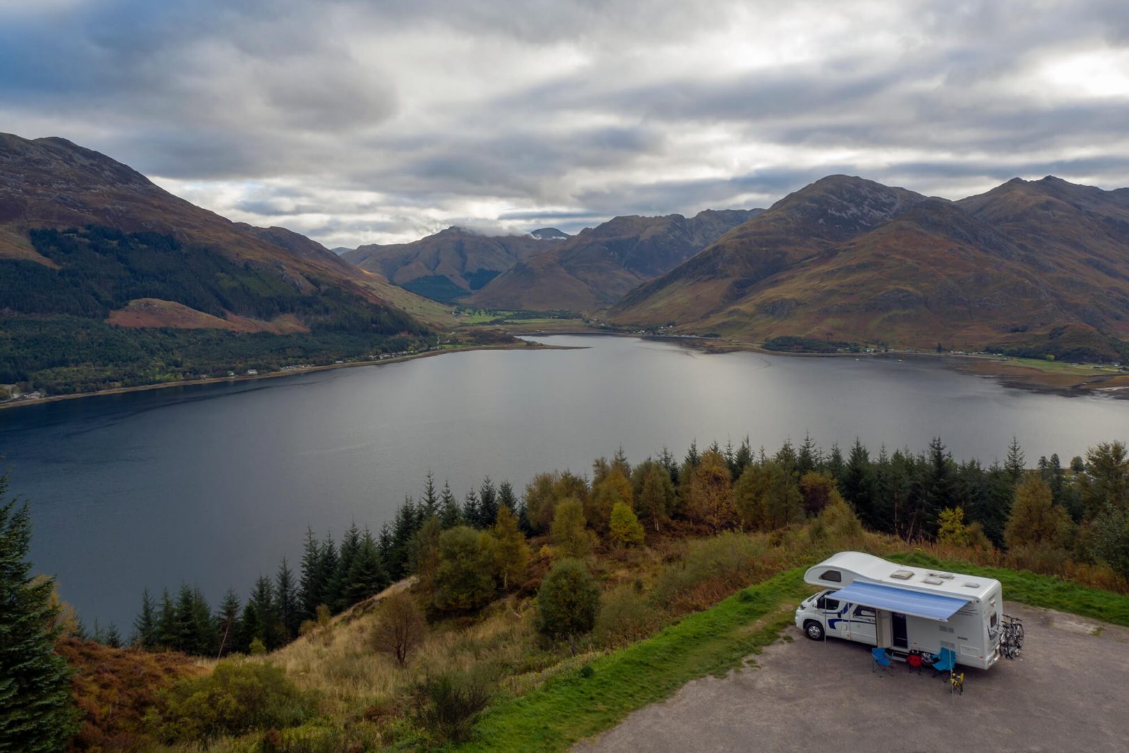 A motorhome overlooking a Scottish loch and mountains